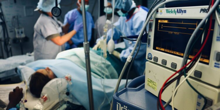 group of people doing a surgery on a person inside the operating room